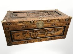 An oriental carved camphor wood blanket box, 89 cm x 43 cm x 36 cm.