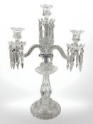 A Baccarat four-light three-branch table candelabrum with foliate sconces and crystal drop lustres,