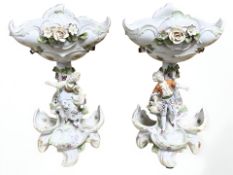 A pair of 20th century German porcelain figural sweet meat dishes in the style of Meissen,