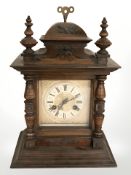 An early 20th century beech mantle clock, striking on a gong, height 39 cm.