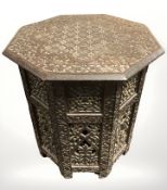 An Anglo-Indian heavily carved octagonal occasional table, height 50 cm.