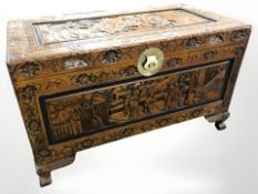 An oriental carved camphor wood blanket box, 102 cm x 53 cm x 60 cm.
