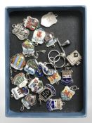 Approximately twenty silver and enamel fobs.