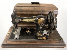 A Jones hand sewing machine in box.