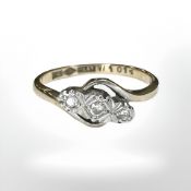 An 18ct gold and platinum three stone diamond twist ring,
