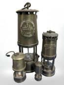 An Eccles Type 6 brass miner's lamp and three further smaller examples