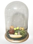A Victorian wax fruit and nut display in basket, under glass dome on stand, height 44cm.
