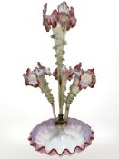A Victorian glass epergne with four flower holders in clear glass fading into vaseline,
