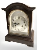 An early 20th century mantel clock with silvered dial and Junghans movement, with pendulum,