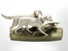 A Royal Dux figure group of two hounds pursuing a pheasant,