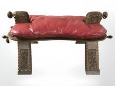 A carved camel stool with cushion