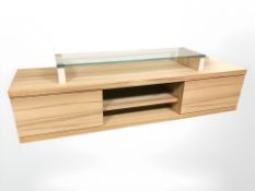 A contemporary low entertainment sideboard with glass stand above,