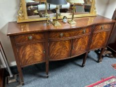 A reproduction mahogany serpentine front sideboard,