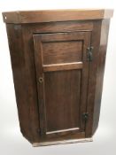 A George III oak corner cabinet, height 112 cm.