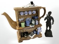 A Ringtons collector's teapot and a patinated metal statue of a man