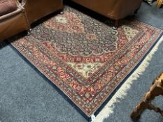 A machine made carpet of Persian design,