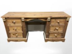 A modern pine twin pedestal dressing table, 164 cm x 44 cm x 79 cm.