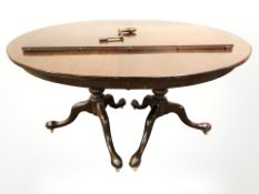 A mahogany oval extending dining table with leaf and five various chairs