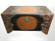An oriental carved camphor wood blanket box, 107 cm x 55 cm x 59 cm.