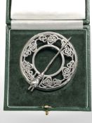 A silver Celtic knot shawl/kilt brooch with wolf's head pin, diameter 6 cm.