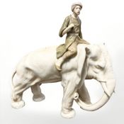 A Royal Dux figure of a man astride an elephant, stamped 1890 9 to underside, length 27 cm.