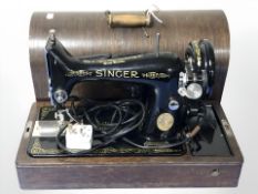 A Singer electric sewing machine in oak case