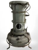 An enameled paraffin stove, height 53 cm.