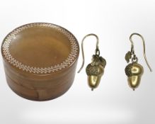 A tortoiseshell box with gold inlay containing a pair of 19th century gold acorn earrings,