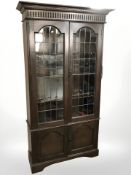A late Victorian oak and leaded glass bookcase, retailed by Gullachsen & Son Limited,