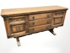 An oak linen fold sideboard,