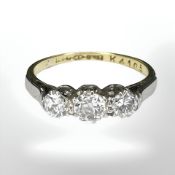 An 18ct gold and platinum three stone diamond ring, size L CONDITION REPORT: 2.
