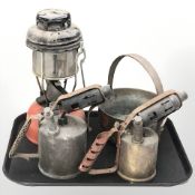 A tilley lamp, two blow torches, a jam pan and a large 19th century cooking pan.