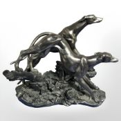 An Academy bronzed resin figure group of two greyhounds,