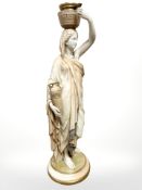 A Royal Worcester blush ivory figure of a Grecian female water carrier,