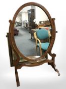 An early 20th century mahogany oval dressing table mirror, height 66 cm.