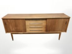 A 20th century teak sliding door low sideboard,