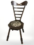 An oak ladder back chair on splayed legs with tapestry seat, height 78 cm.