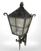 A wrought metal outdoor lantern with bracket, height 70 cm.