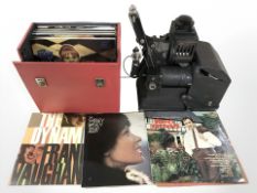 A projector and a case of LP records.