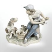 A Lladro figure group of a boy and dogs, No. 5376, height 18 cm.