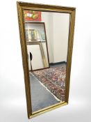 A contemporary bevelled gilt framed mirror, 58 cm x 118 cm.