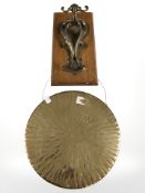 A brass gong on bracket.