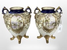 A pair of L & Co. Nippon twin handled gilt porcelain vases decorated with landscapes, height 18 cm.
