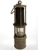 A brass and gauze miner's lamp, height 29 cm.