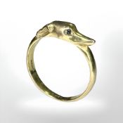 A 9ct gold dog ring, modelled as a greyhound with sapphire set eyes,