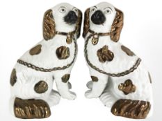 A pair of continental copper lustre Staffordshire-style dogs, height 23.5 cm.