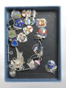 Approximately twenty silver and enamel fobs.