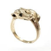 A 9ct gold dog ring, modelled as two greyhounds with sapphire set eyes,