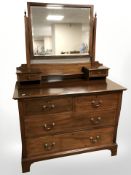 A late Victorian mahogany and satinwood banded four drawer mirror back dressing table,