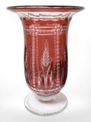 A Victorian flash cut cranberry glass trumpet vase with clear foot, height 28 cm.